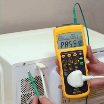 Image of a PAT tester being used on a microwave, showcasing the process of Portable Appliance Testing (PAT Testing) in Lancaster. This testing is crucial for ensuring electrical safety in businesses, rental properties, and public spaces. Services include PAT Testing for landlords, offices, retail shops, and construction sites in the Lancaster area, helping to meet compliance with Health & Safety Executive guidelines.