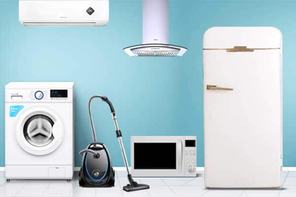 A collection of household appliances including a washing machine, vacuum cleaner, microwave, and refrigerator, representing the types of equipment that require PAT testing in Lancaster. PAT testing ensures safety and compliance for businesses and landlords in the Lancaster area.